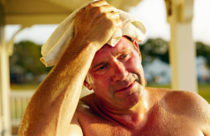 Man with heat exhaustion on a Gulf Coast porch, a condition treated at urgent care in Vancleave, MS
