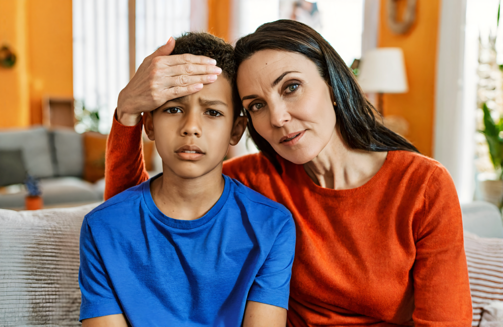 A Pascagoula-area mother checks her son for a fever at home before a same-day clinic visit