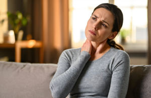 Woman feeling unwell at home considering urgent care near D'Iberville, MS