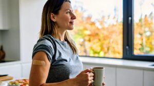 Woman at home in Vancleave MS with a bandage on her arm after a walk in flu shot